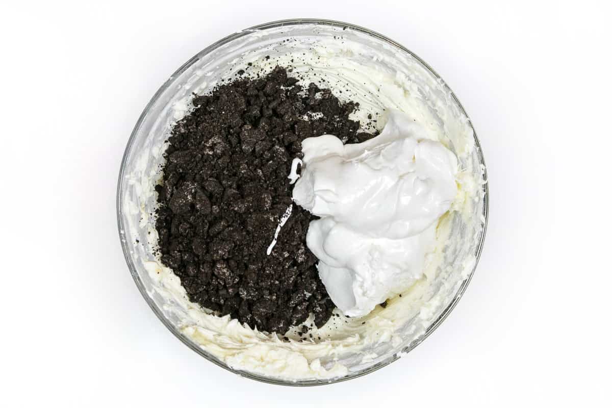 Add the crushed Oreo cookies and Cool Whip to the cream cheese mixture.