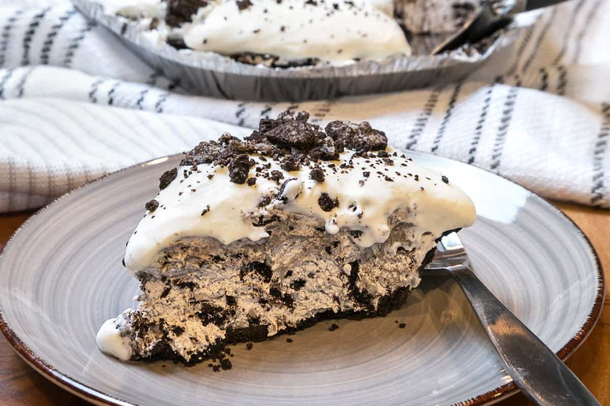 A slice of Oreo cheesecake on a plate.