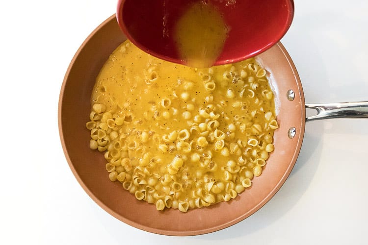 The egg mixture is added together with the cooked pasta noodles.