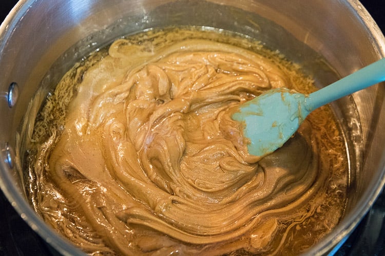 Melted peanut butter and honey in a saucepan.