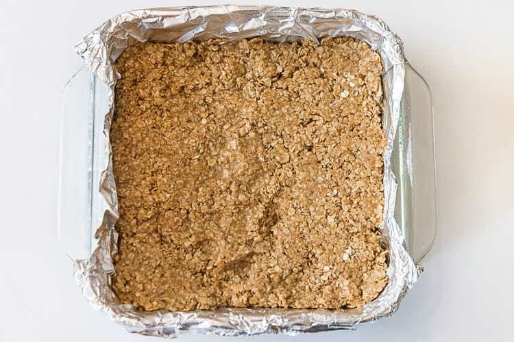 Line a pan with aluminum foil, then spray with cooking spray, and add the peanut butter mixture.