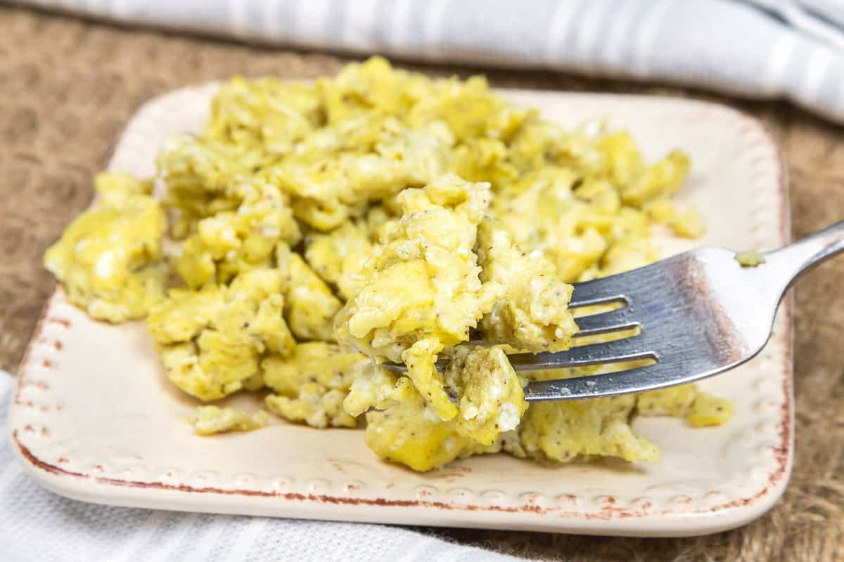 Olive oil scrambled eggs without milk on a plate.
