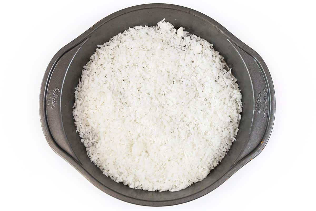 Fill the bottom of a pie dish with coconut flakes.
