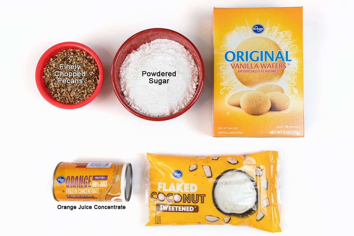 Ingredients for Orange balls. One cup of finely chopped pecans, two cups of powdered sugar, eleven ounces of vanilla wafers, six ounces of frozen orange juice concentrate, and two cups of sweetened coconut flakes.