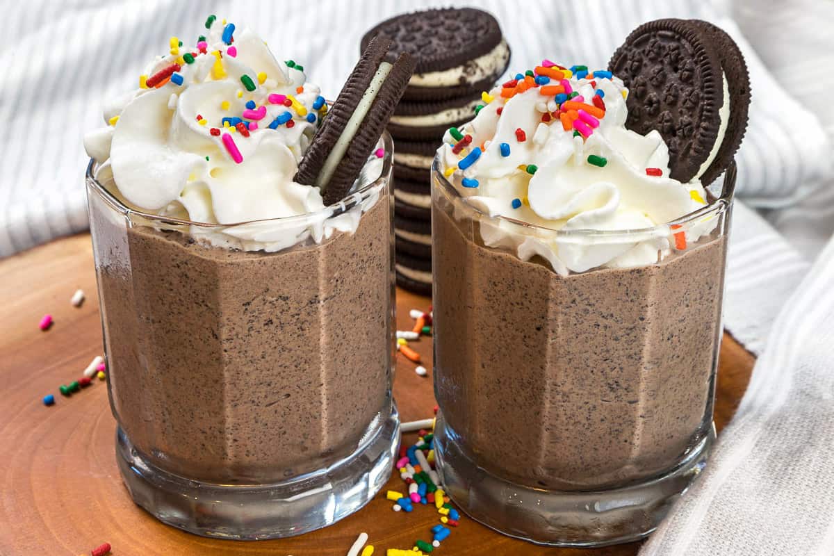 Oreo chocolate milkshake with whipped cream on top.