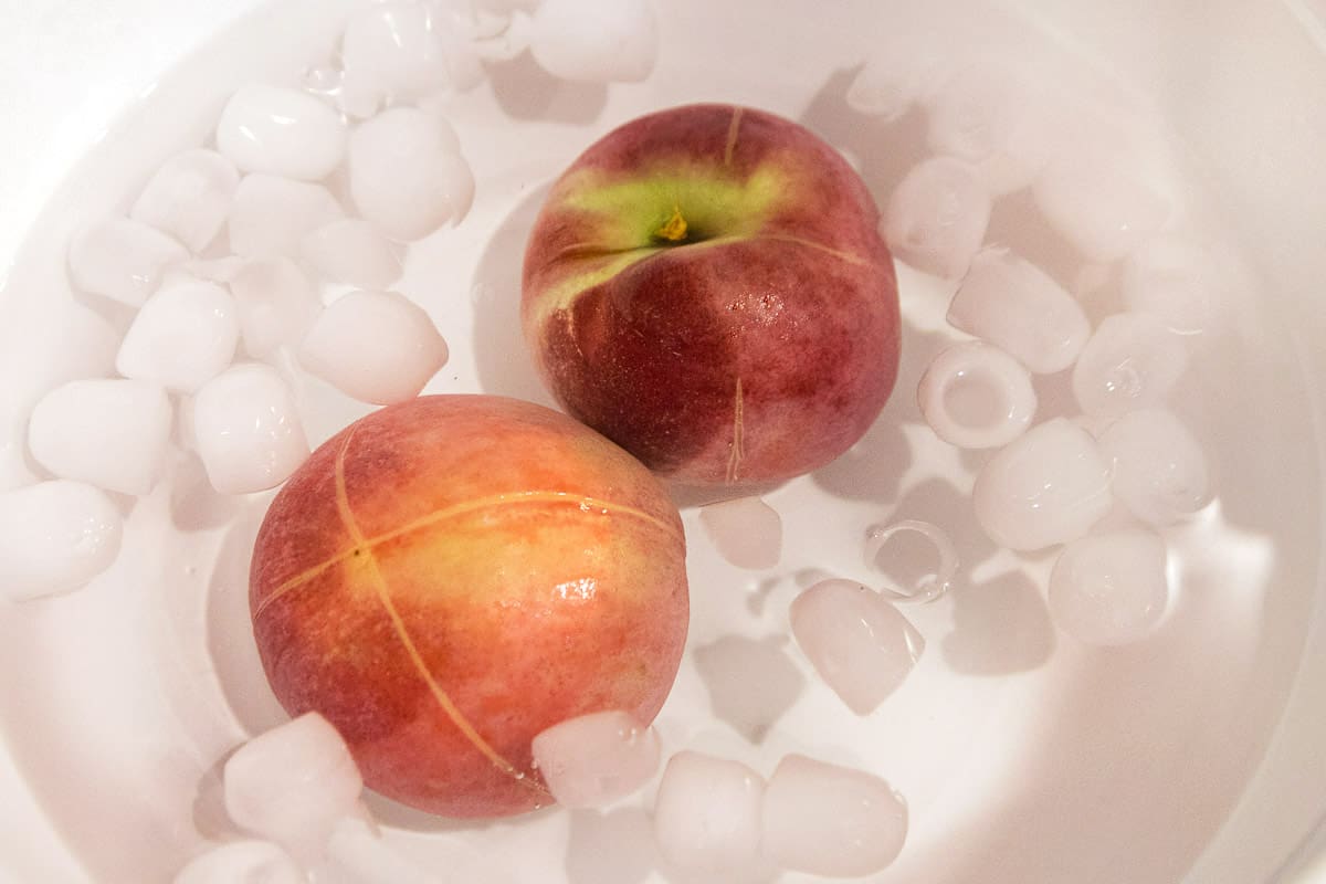 Put peaches in an ice bath for about one minute.
