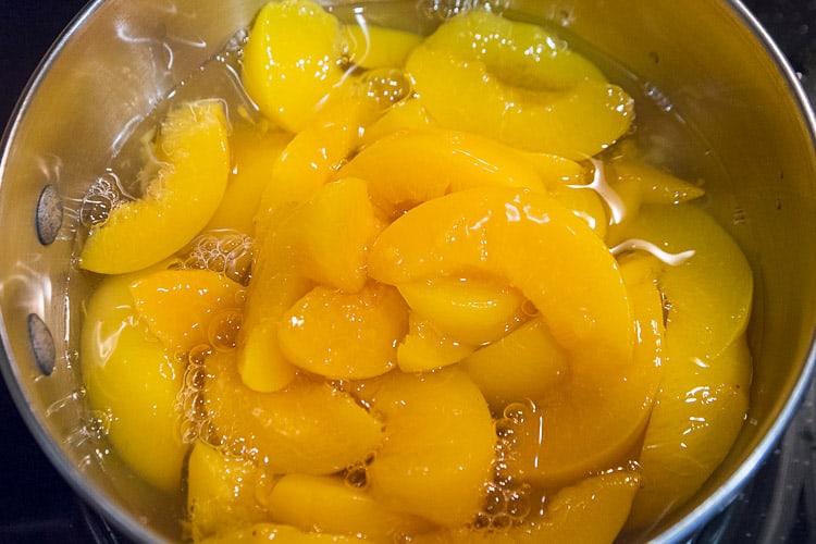 Two cans of peaches in a pot