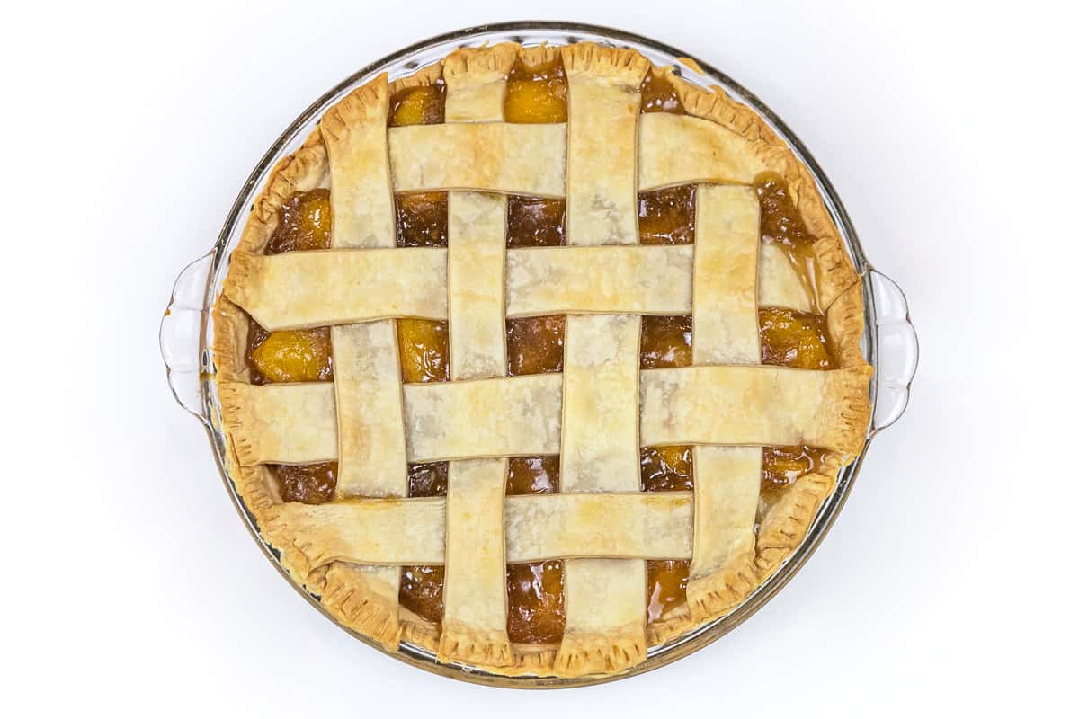 Peach pie after baking in the oven at three hundred and fifty degrees Fahrenheit for forty to fifty minutes or until golden brown.