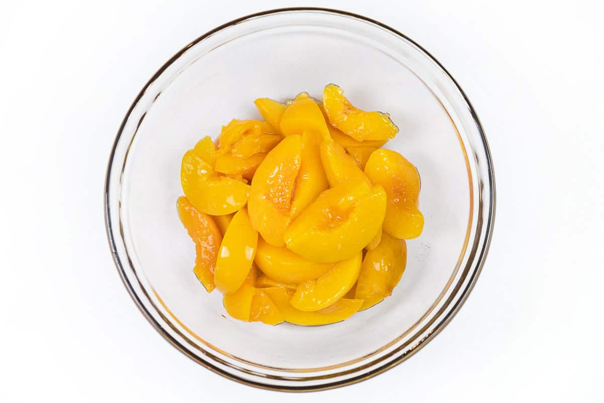 Put the peaches into a large mixing bowl.