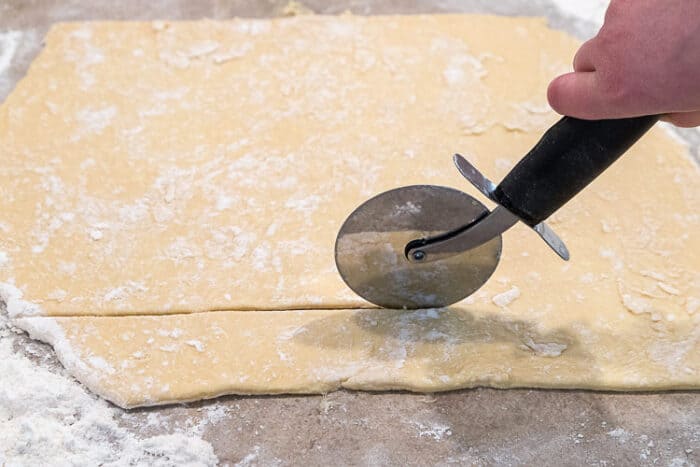 Cutting the pierogi dough into squares.
