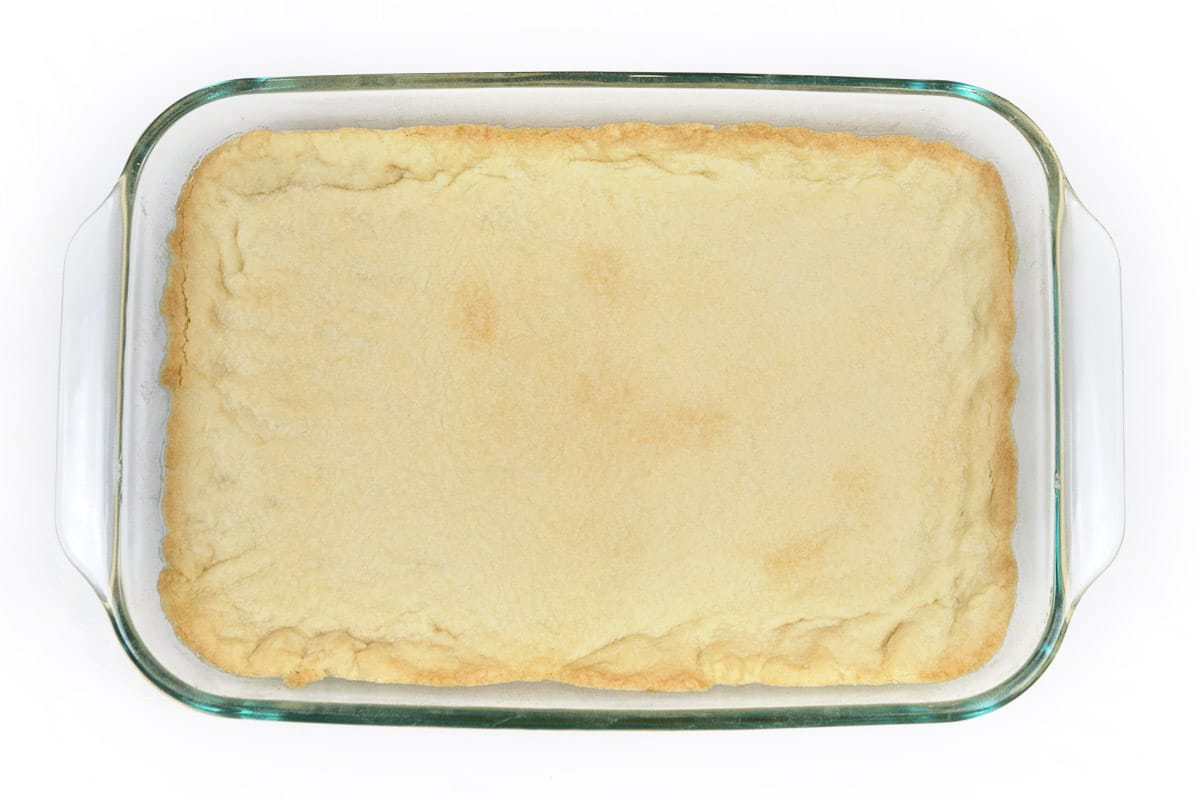 A baked homemade pie crust in a nine by thirteen inch baking dish.