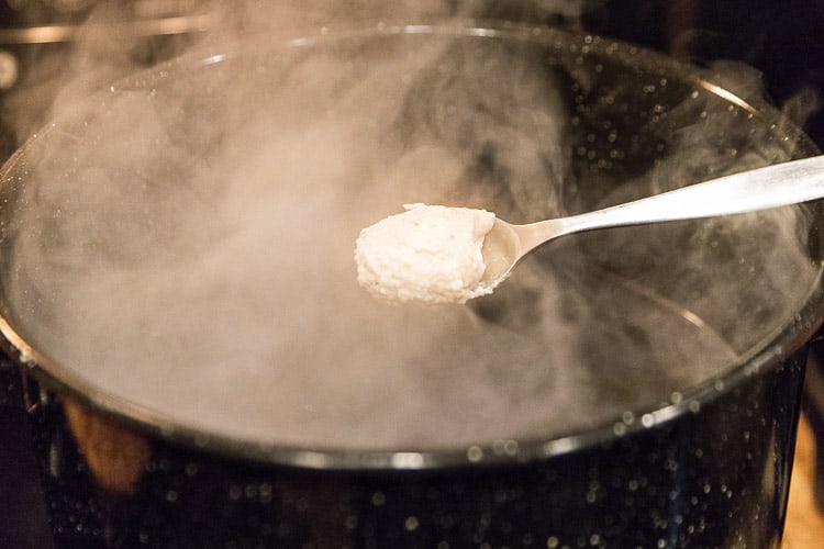 Cooking the potato dumplings in a pot of boiling water.