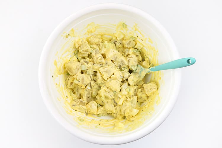 Mix potatoes with the hard-boiled eggs, celery, chopped onion, sweet relish, salt, pepper, mayonnaise, and yellow mustard in the bowl.