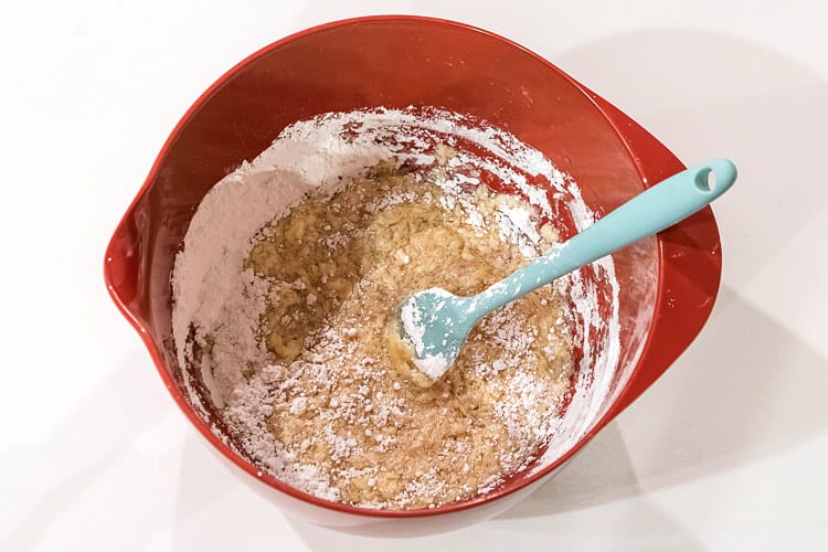 Mix three cups of powdered sugar with one-half cup of softened butter.