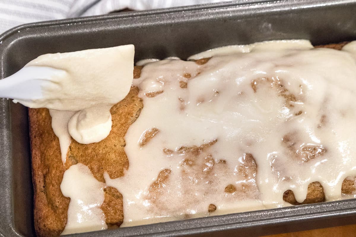 Powdered sugar icing spread on top of the applesauce cake.