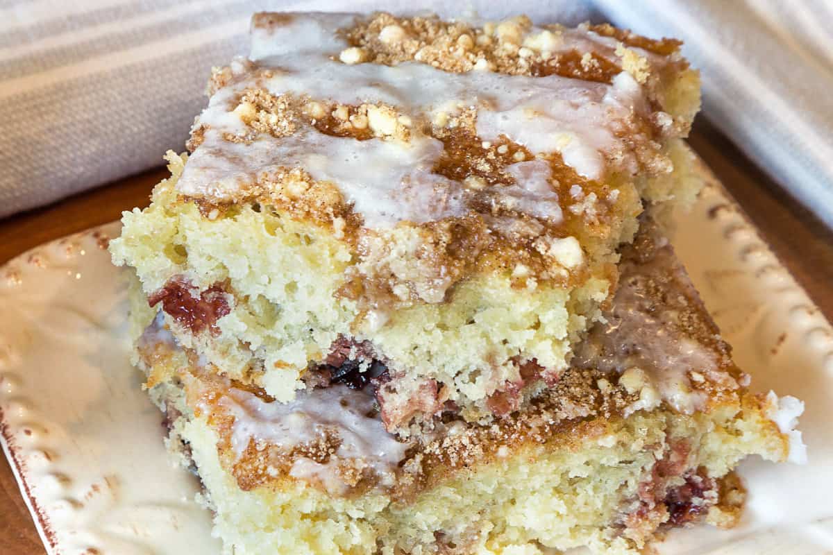 Icing on top of cherry coffee cake.