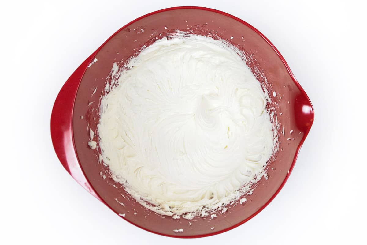 Whipped cream cheese and sugar in a large bowl.