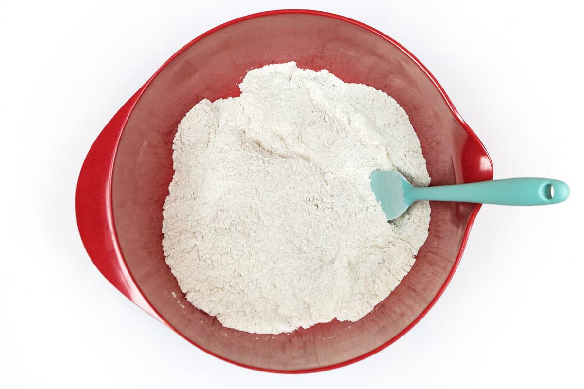 Flour, baking powder, light brown sugar, and table salt mixed in a bowl.