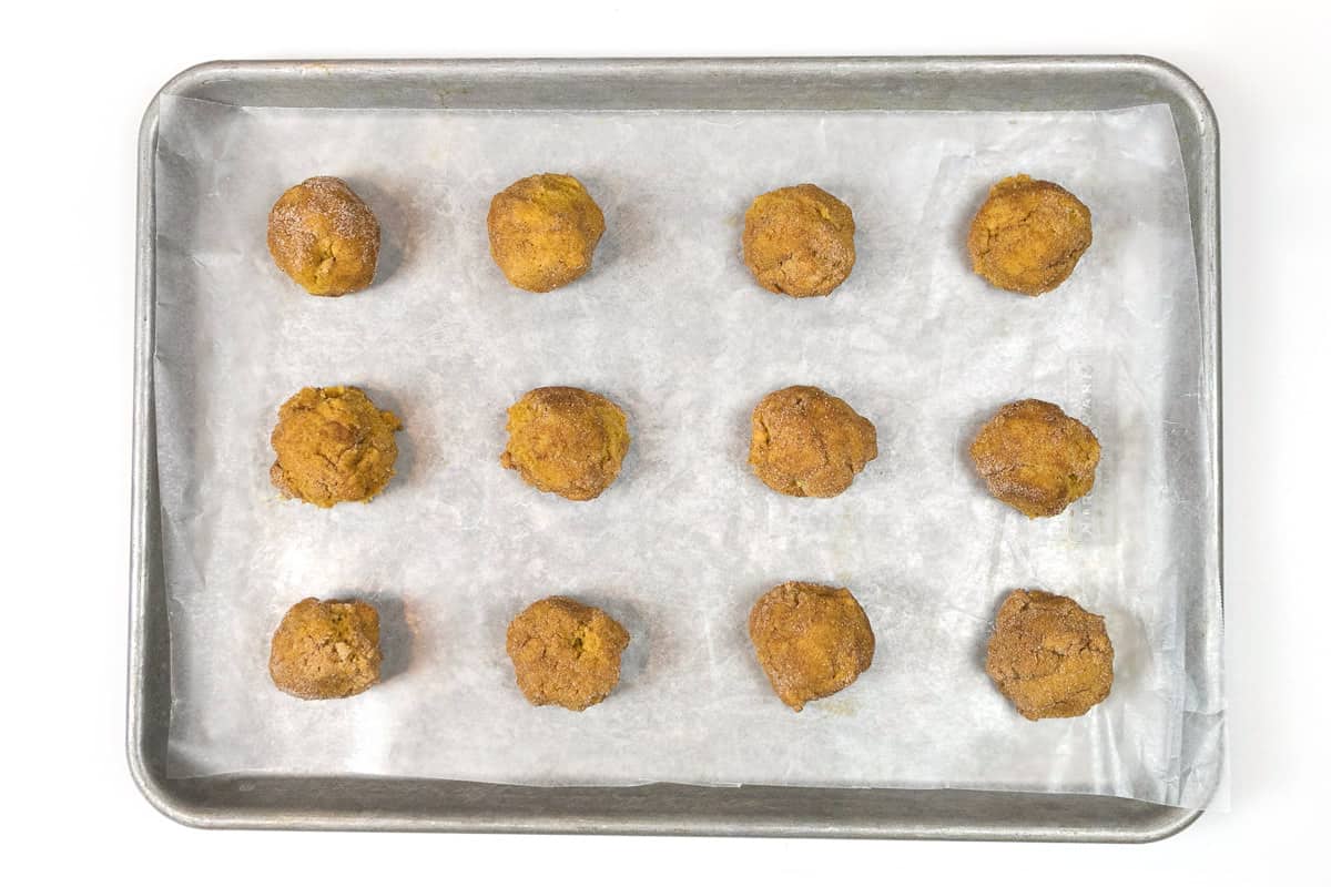 Put parchment paper on a cookie sheet, then cookie dough balls two inches apart.
