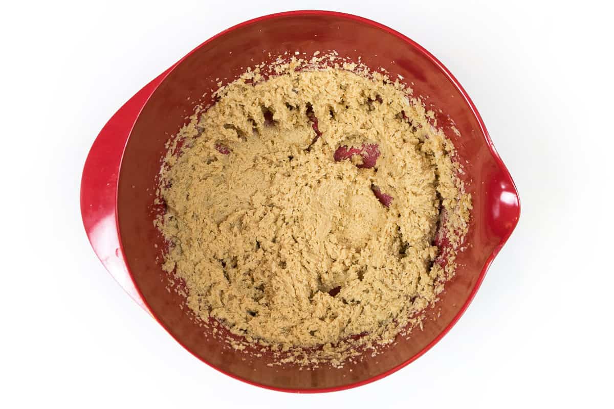 Melted butter, granulated sugar, and light brown sugar are mixed in a bowl.