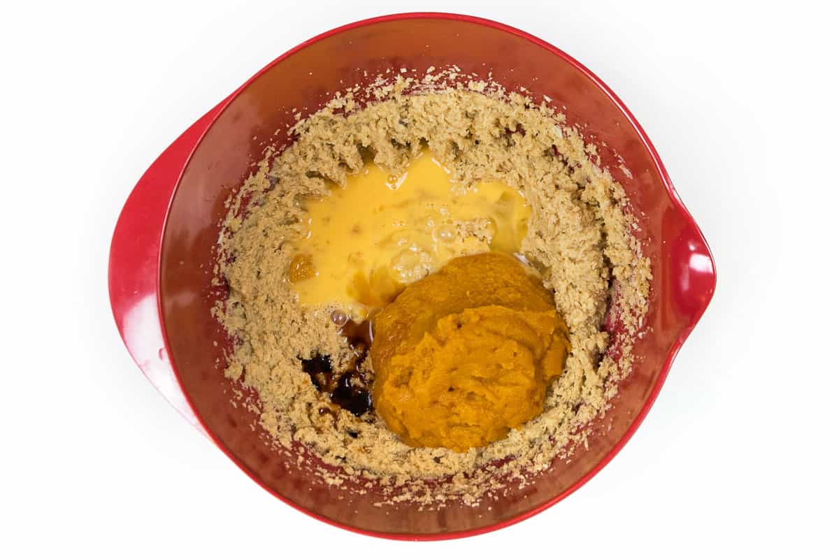 The beaten eggs, pumpkin puree, and vanilla extract are added to the butter and sugar mixture.