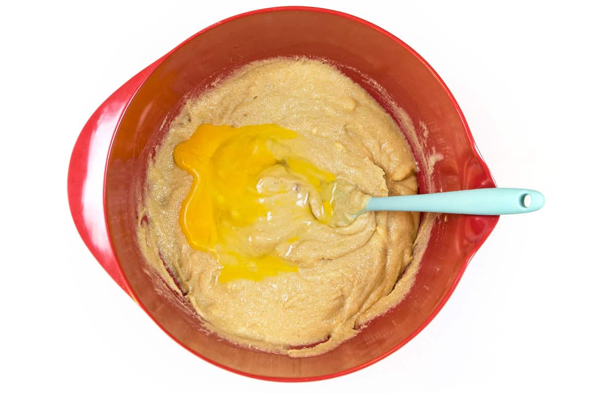 Add four eggs (one at a time) to the melted butter, granulated sugar, brown sugar, and vanilla extract.