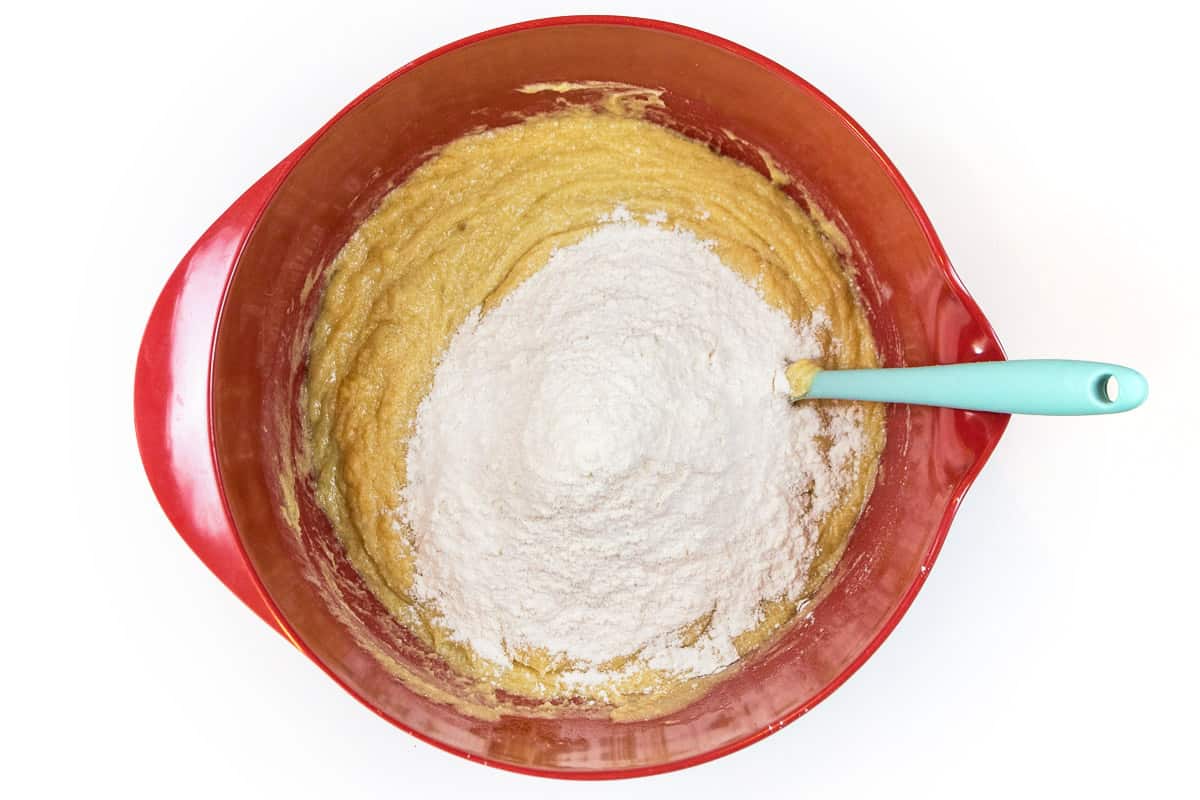 Slowly add the flour mixture to the creamy cookie dough mixture.