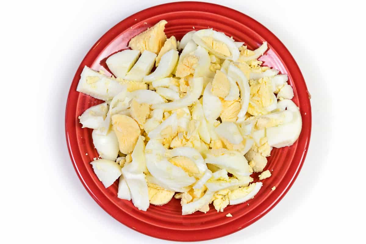 Hard-boiled eggs sliced on a plate.