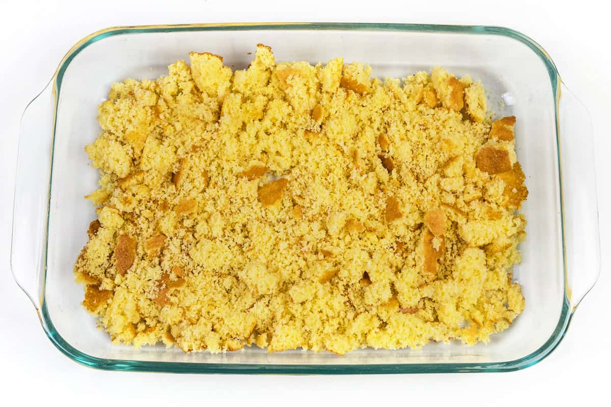 Crumbled cornbread in a baking dish.