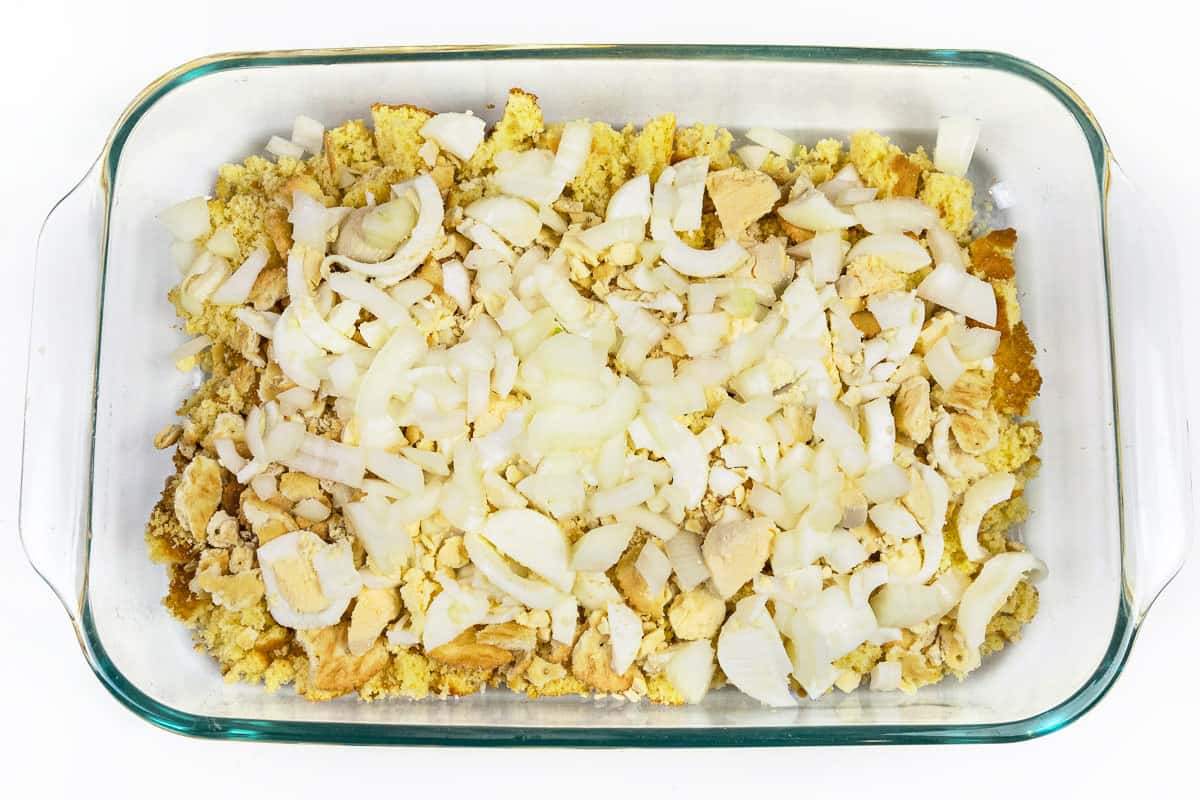 Sliced onions over the top of the sliced hard-boiled eggs, crumbled Ritz crackers, and crumbled cornbread in a baking dish.