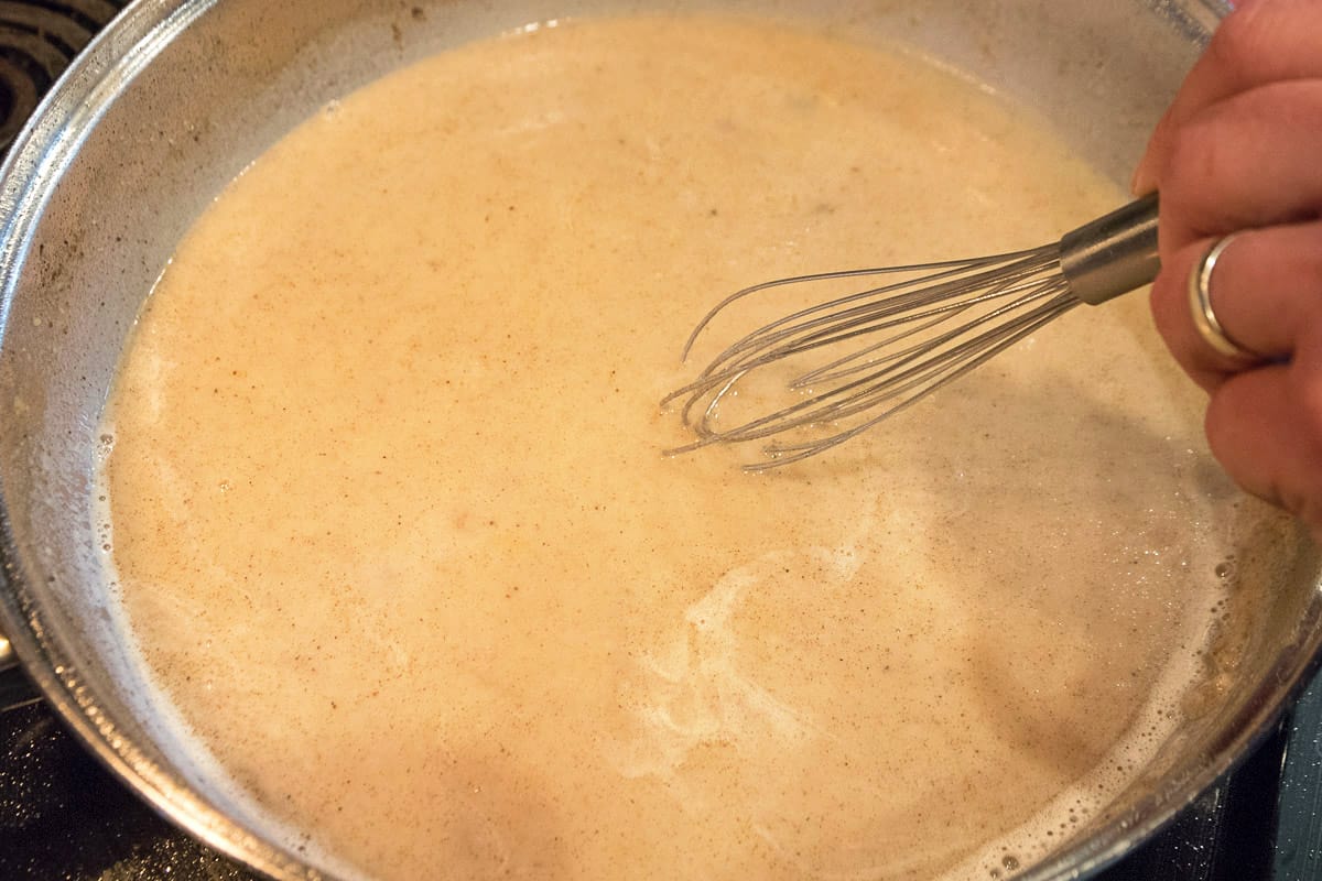Add one-fourth teaspoon of table salt, one-fourth teaspoon of black pepper, one-eight teaspoon of cayenne pepper, and one-eight teaspoon of garlic powder and any other seasonings you like. Continue to stir and to cook over medium heat until desired thickness. Our gravy took about ten minutes to thicken.