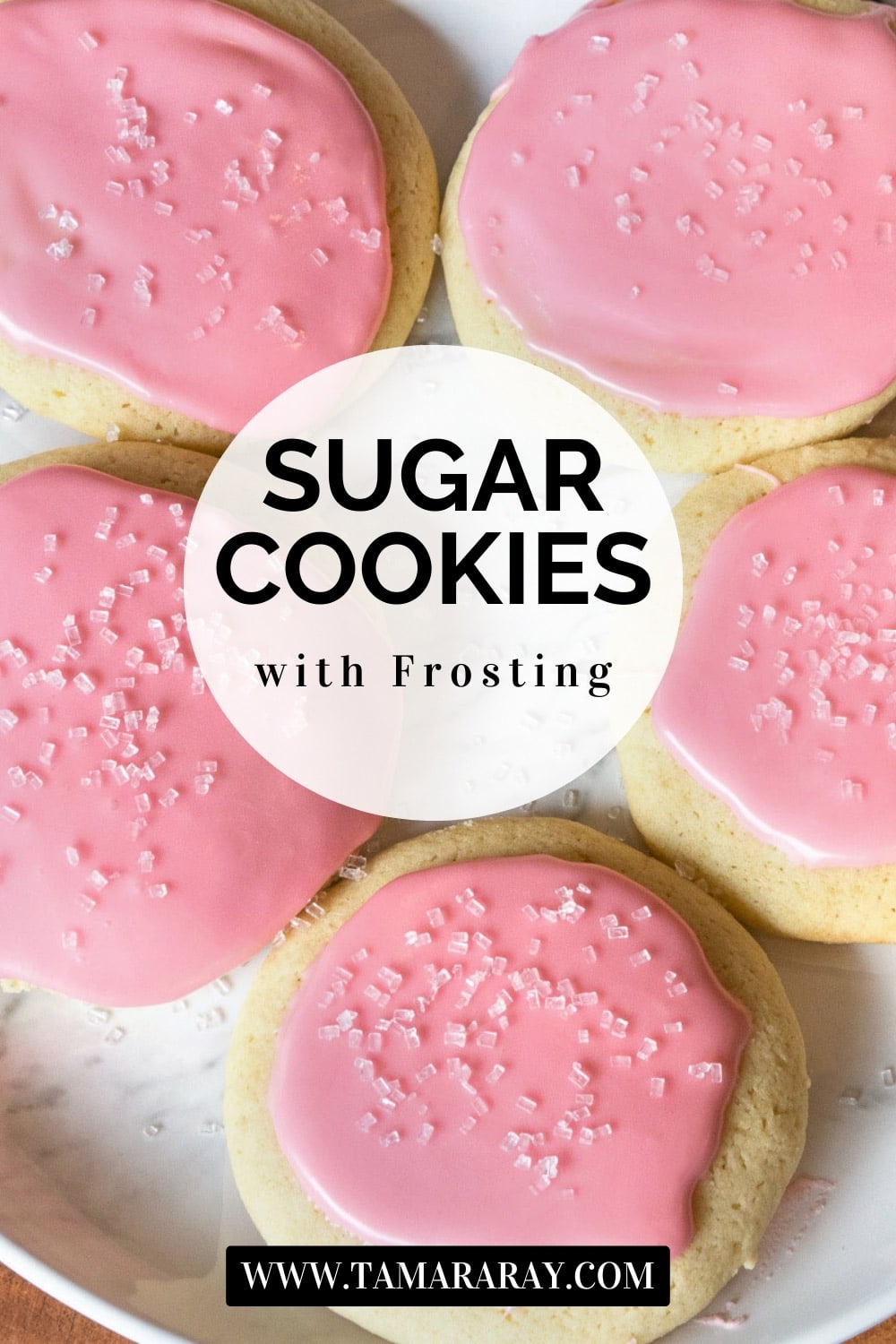 Five sugar cookies with frosting on a plate.