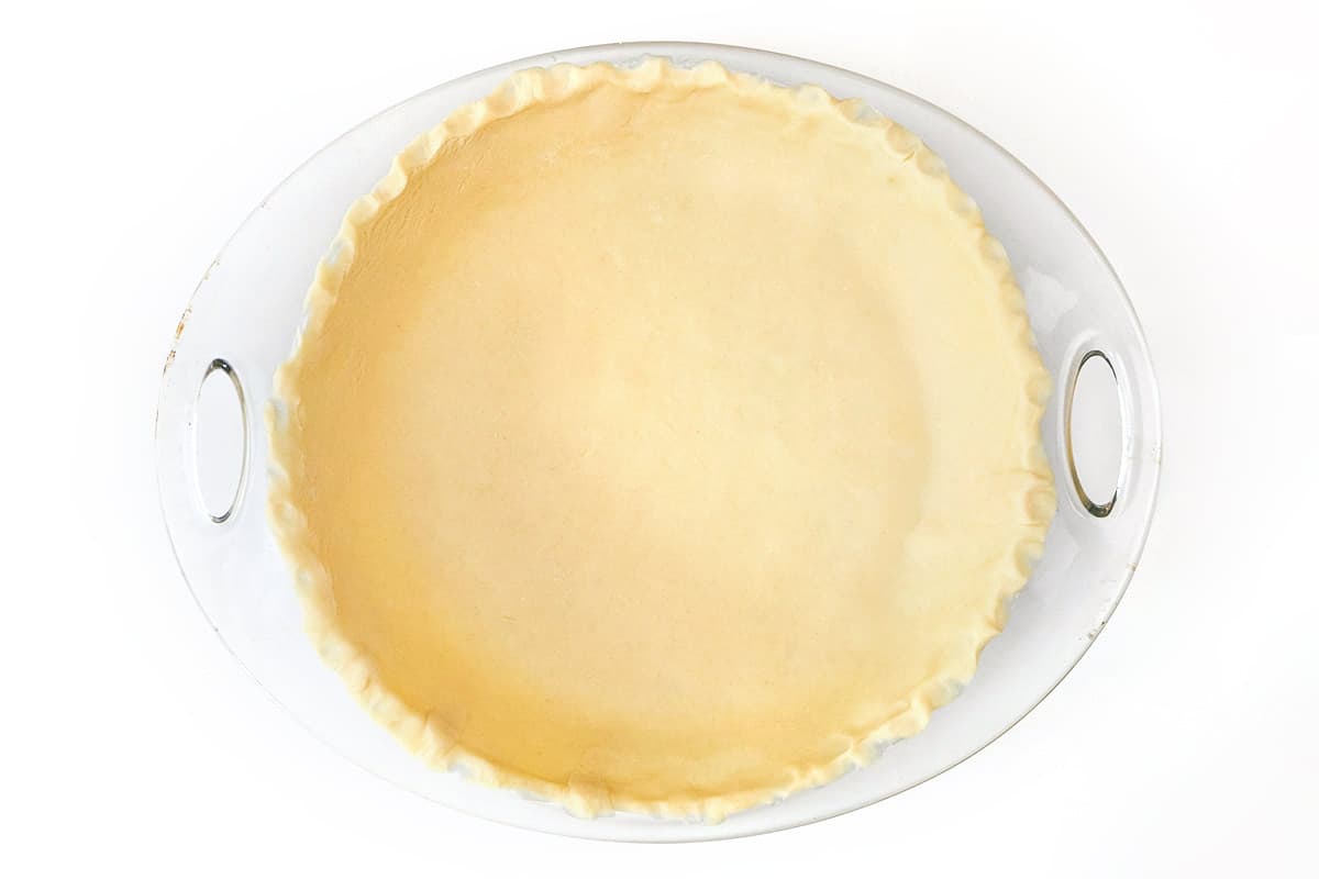 Premade pie dough in a nine-inch round pie dish.