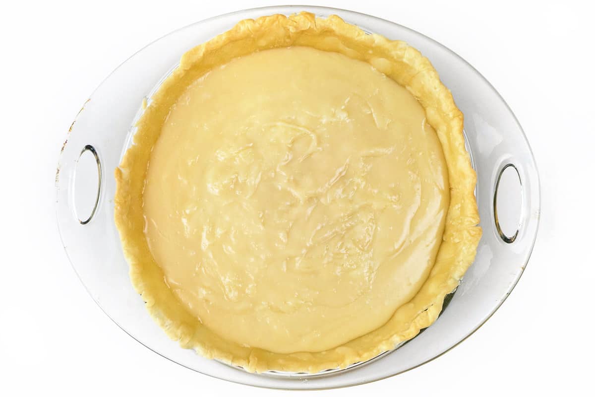 Pour the thickened cream mixture into the partially baked pie crust.