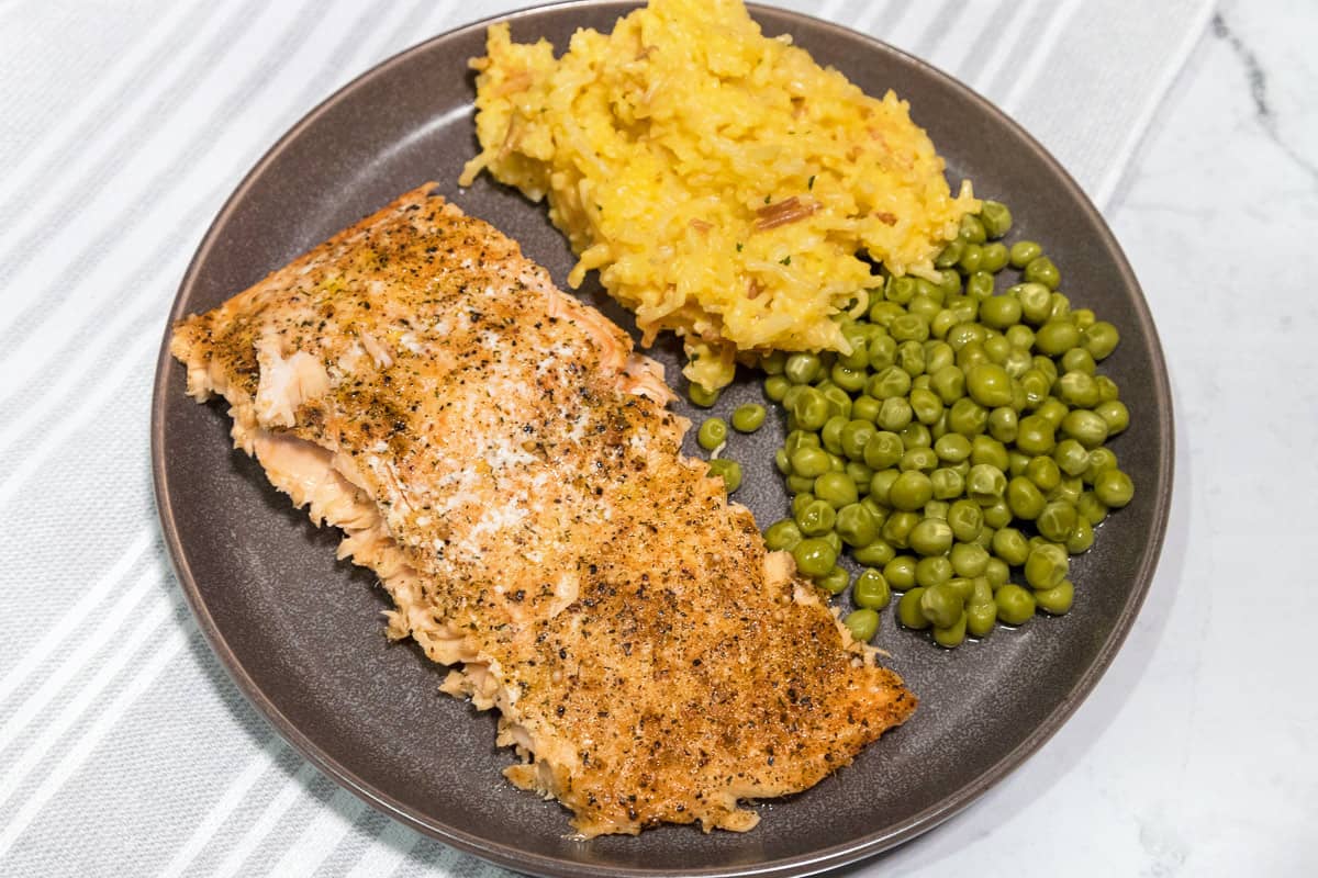 Easy whole baked salmon filet with rice and peas.