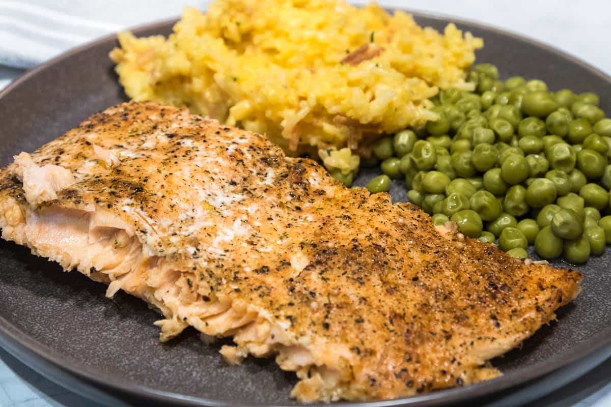 Easy whole baked salmon filet with rice and peas.